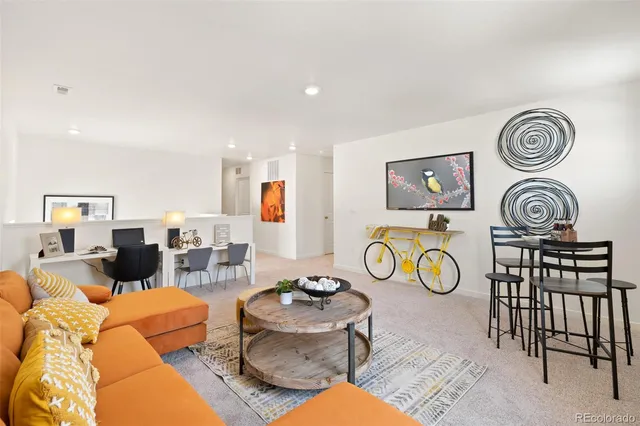 a living room with furniture and kitchen view
