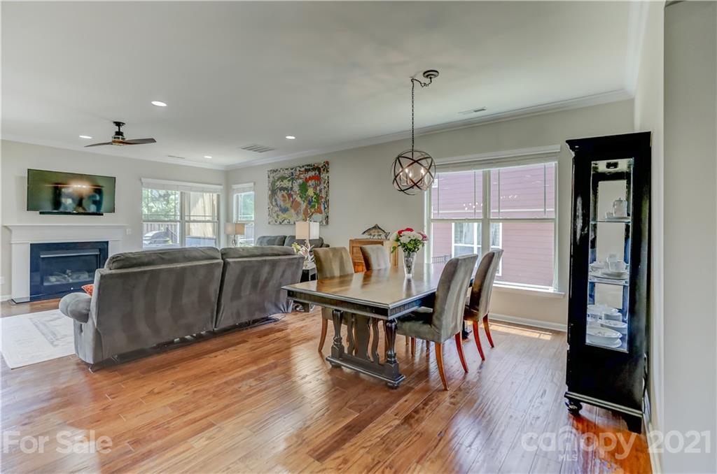 5202 Waterloo Drive Tega Cay, SC 29708 - Photo 11 of 44 a view of a dining room with furniture window and wooden floor