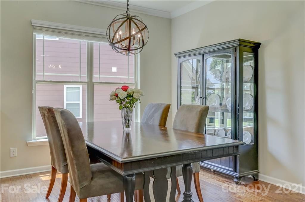 5202 Waterloo Drive Tega Cay, SC 29708 - Photo 12 of 44 a view of a dining room with furniture window and wooden floor