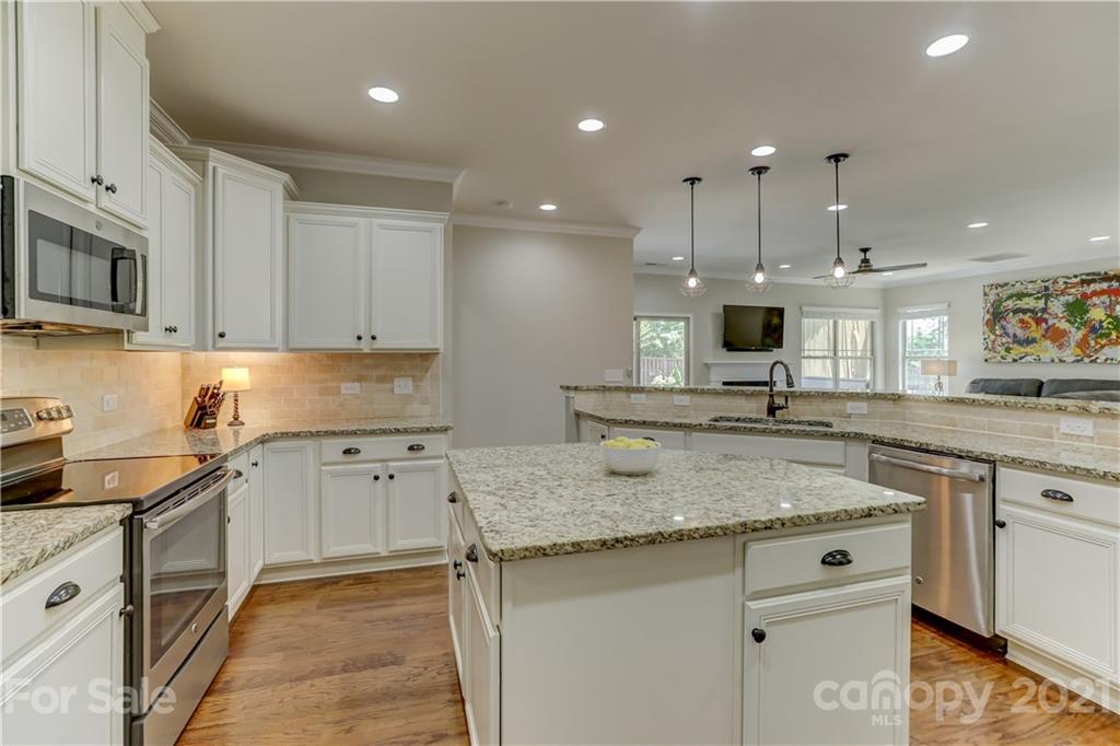 5202 Waterloo Drive Tega Cay, SC 29708 - Photo 18 of 44 a kitchen with stainless steel appliances granite countertop a sink a stove and a granite counter tops