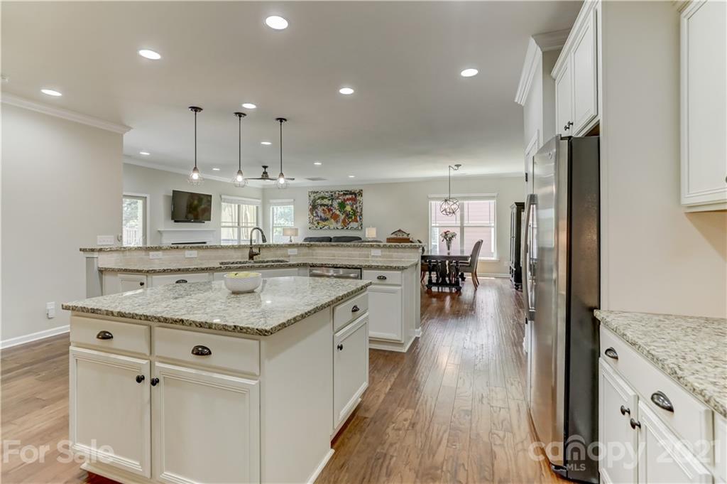 5202 Waterloo Drive Tega Cay, SC 29708 - Photo 19 of 44 a kitchen with stainless steel appliances granite countertop a lot of counter space and wooden floors