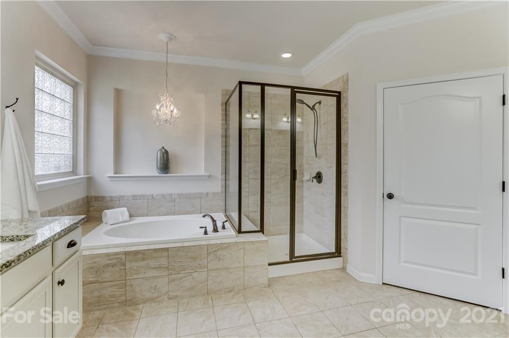 5202 Waterloo Drive Tega Cay, SC 29708 - Photo 23 of 44 a spacious bathroom with a tub shower and mirror
