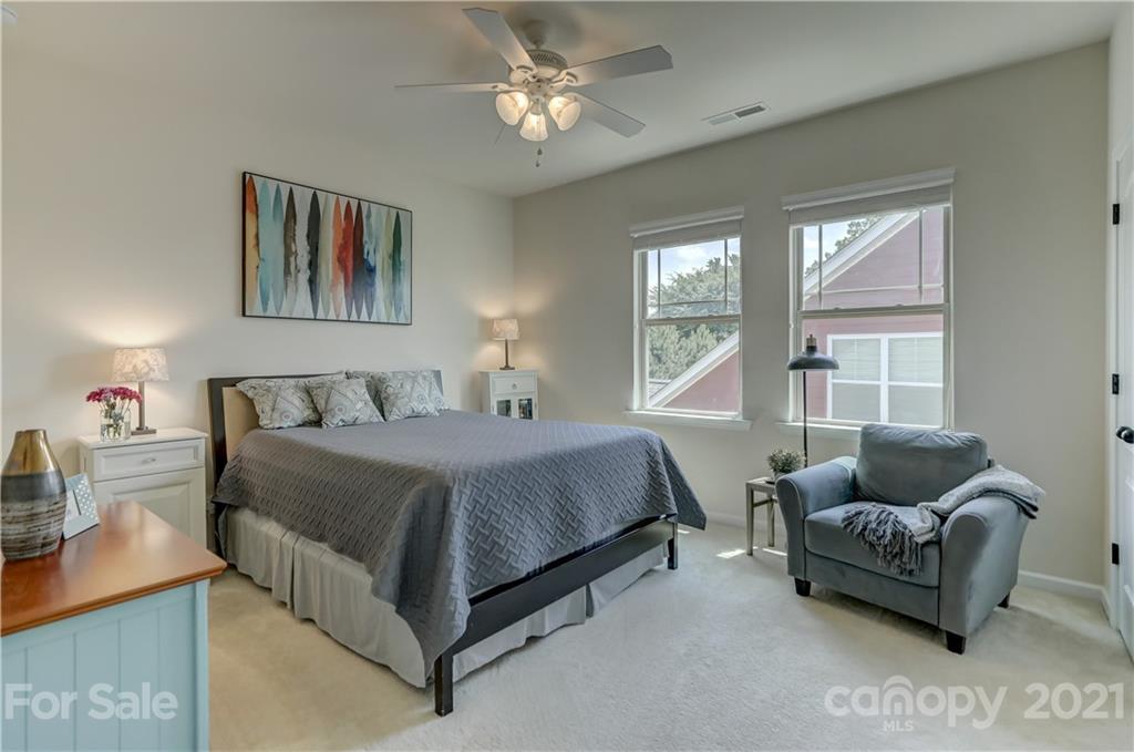 5202 Waterloo Drive Tega Cay, SC 29708 - Photo 34 of 44 a spacious bedroom with a bed and couch