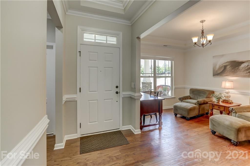 5202 Waterloo Drive Tega Cay, SC 29708 - Photo 6 of 44 a living room with furniture chandelier and wooden floor
