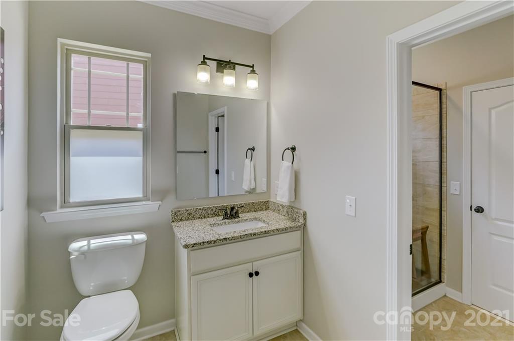 5202 Waterloo Drive Tega Cay, SC 29708 - Photo 9 of 44 a bathroom with a granite countertop toilet sink and mirror