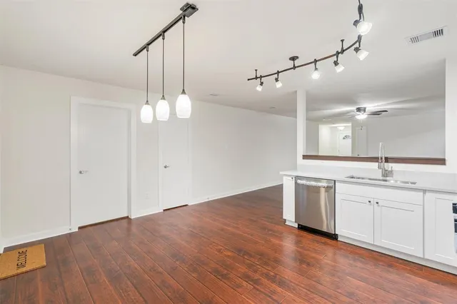 a view of a kitchen with wooden floor and window