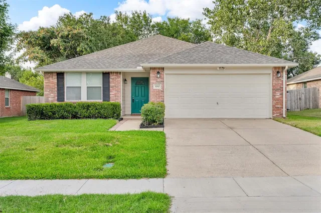 a view of a house with a yard and garage