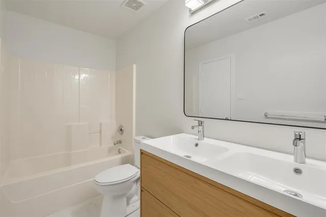 a bathroom with a sink a toilet and a bathtub