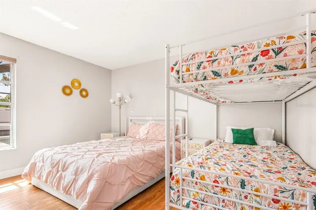 a bedroom with a bed and a painting on the wall