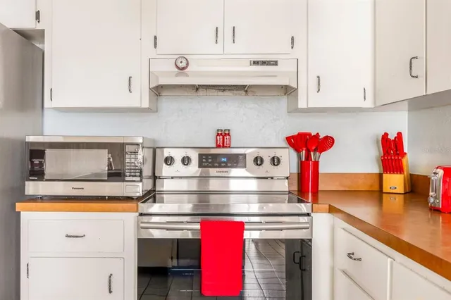 a kitchen with stainless steel appliances granite countertop a sink and cabinets