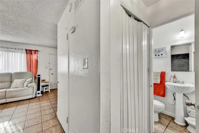 a bathroom with a toilet sink and shower curtain