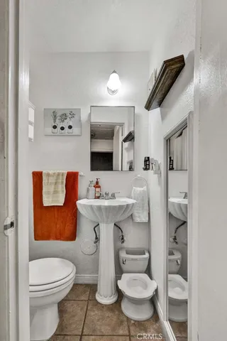 a bathroom with a sink toilet and mirror