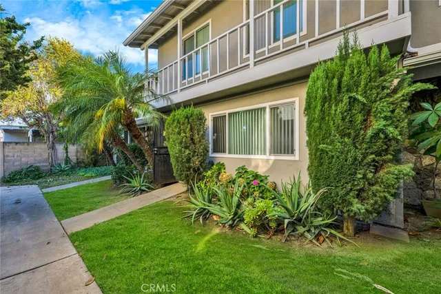 a view of a house with a yard and plants