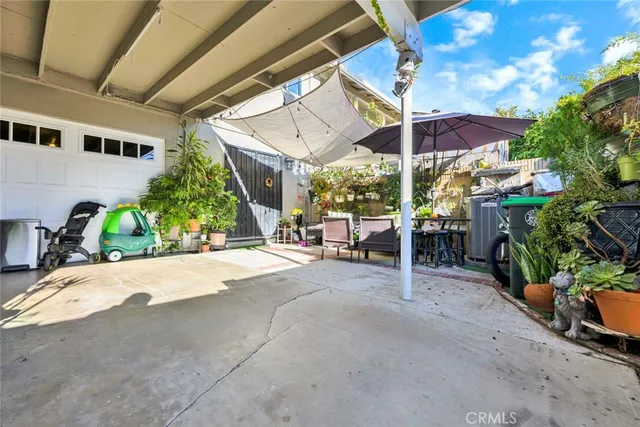 a view of a patio with a table and chairs under an umbrella
