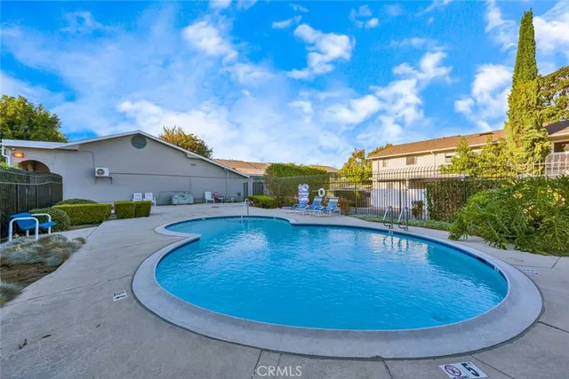 a view of a swimming pool with a yard