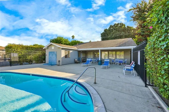 a view of house with swimming pool outdoor seating area and barbeque oven