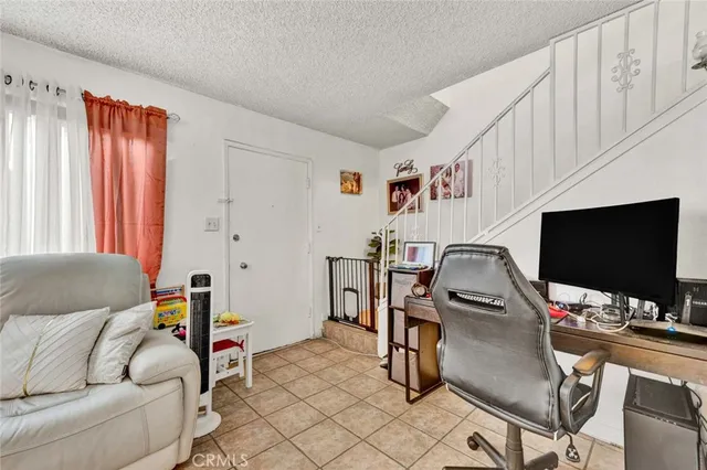 a bedroom with furniture and a flat screen tv