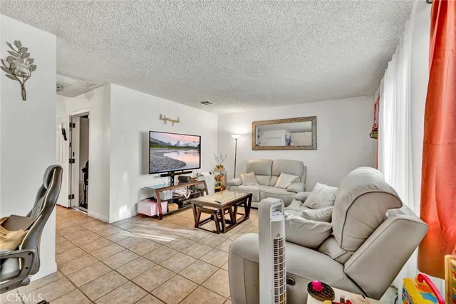 a living room with furniture a rug and a window