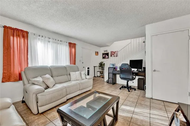 a living room with furniture a rug and a window
