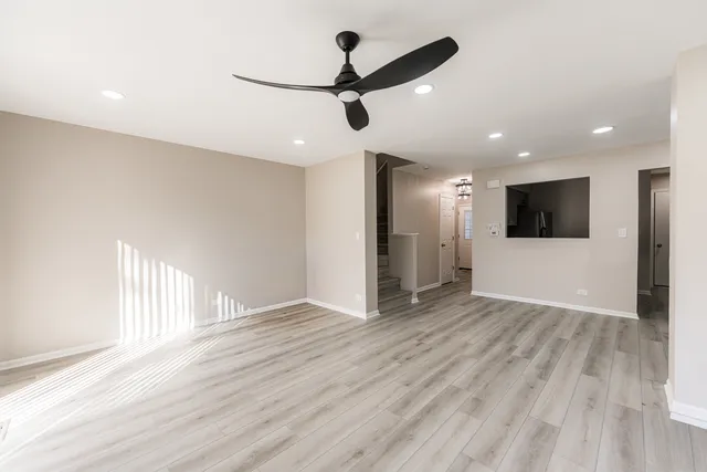 a kitchen with stainless steel appliances granite countertop a refrigerator a sink and a stove