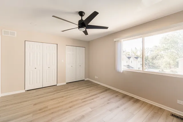 a bathroom with a toilet sink vanity granite and mirror