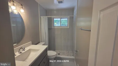a bathroom with a toilet a sink and shower