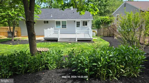 a view of a house with a yard porch and sitting area