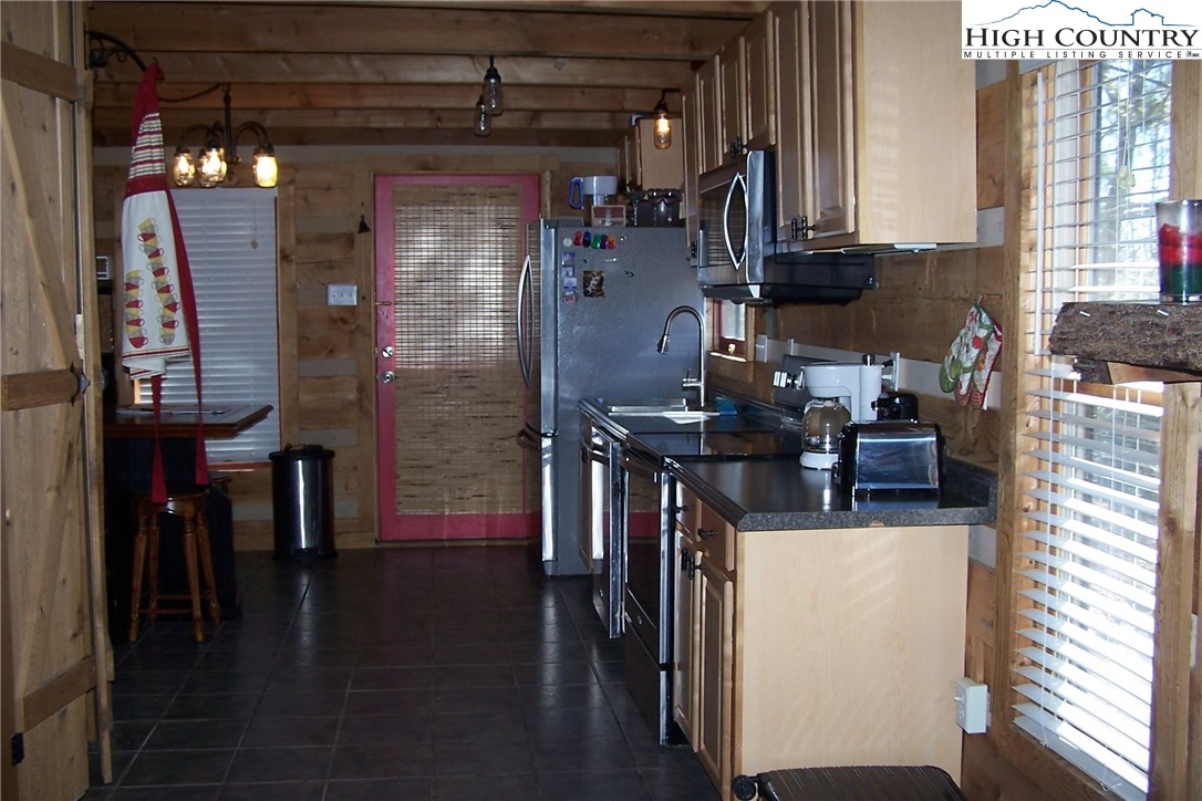 3545 Wildcat Road Deep Gap, NC 28618 - Photo 14 of 24 a kitchen with stainless steel appliances granite countertop a refrigerator and a stove top oven