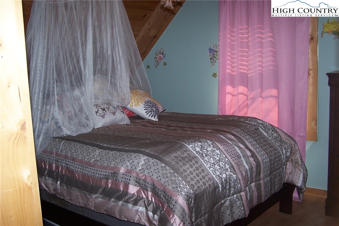 3545 Wildcat Road Deep Gap, NC 28618 - Photo 18 of 24 a bed sitting in a bedroom next to a small yard