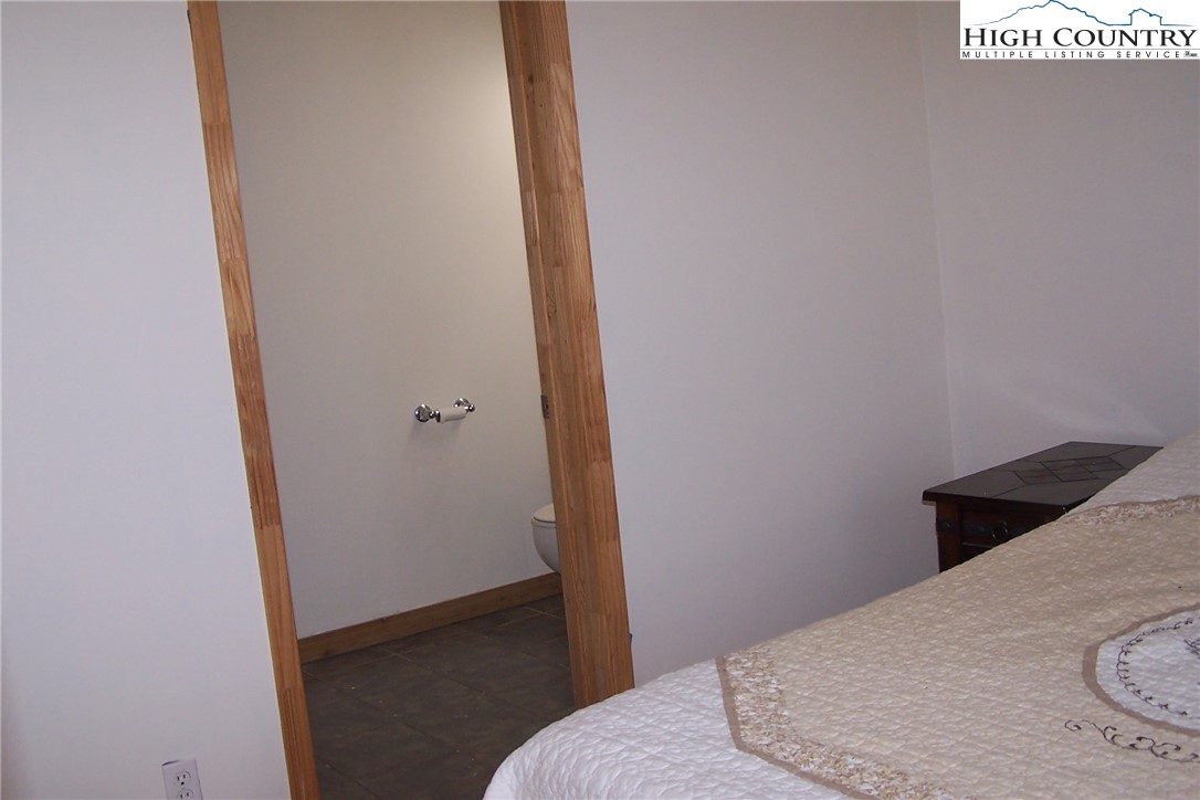 3545 Wildcat Road Deep Gap, NC 28618 - Photo 21 of 24 a bedroom with a bed and a hallway
