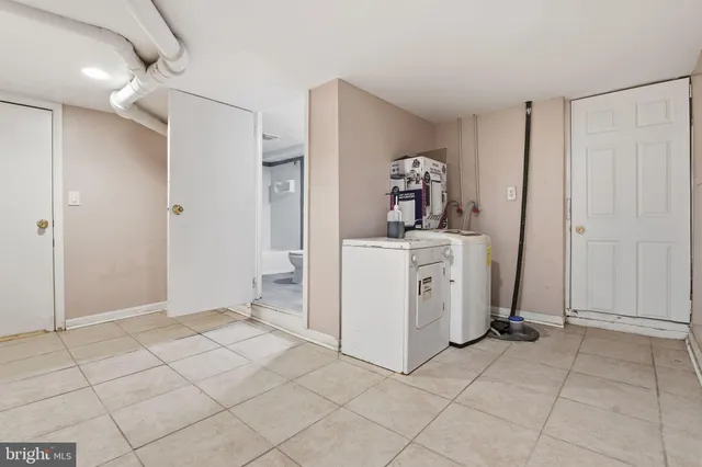 a view of a storage & utility room with two washing machine