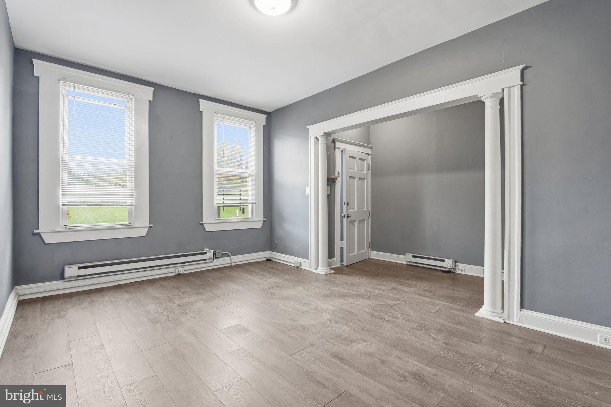5 South Wickham Road, Unit 1 Baltimore, MD 21229 - Photo 3 of 17 an empty room with window and wooden floor