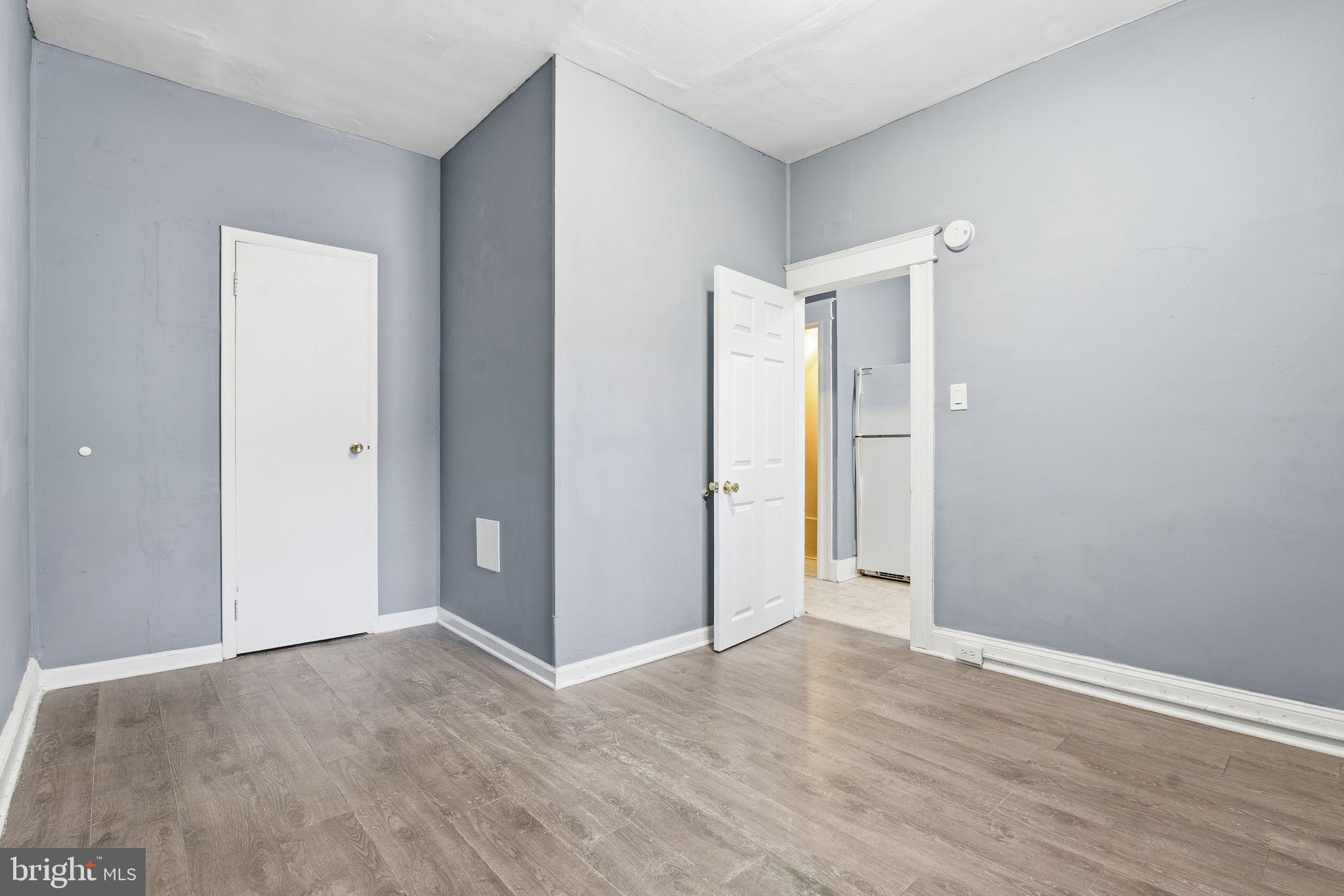 5 South Wickham Road, Unit 1 Baltimore, MD 21229 - Photo 6 of 17 a view of an empty room with wooden floor