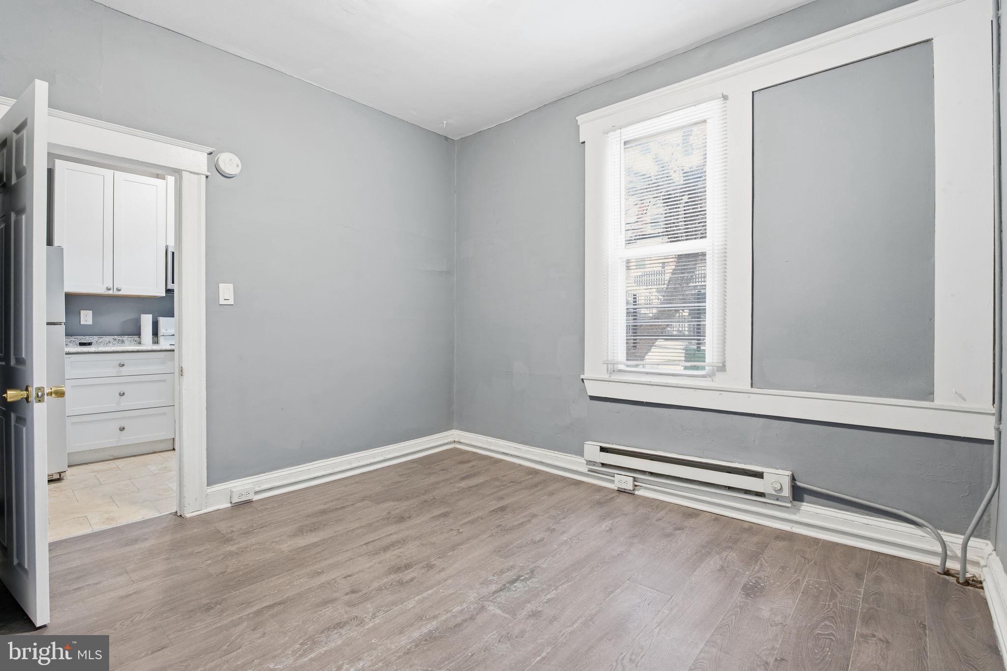 5 South Wickham Road, Unit 1 Baltimore, MD 21229 - Photo 7 of 17 wooden floor in an empty room with a window