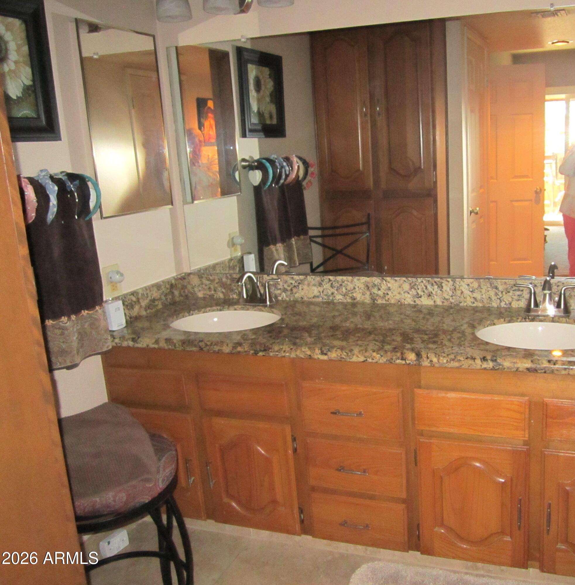 4303 East Cactus Road, Unit 423 Phoenix, AZ 85032 - Photo 12 of 39 a bathroom with a granite countertop sink a mirror and a vanity