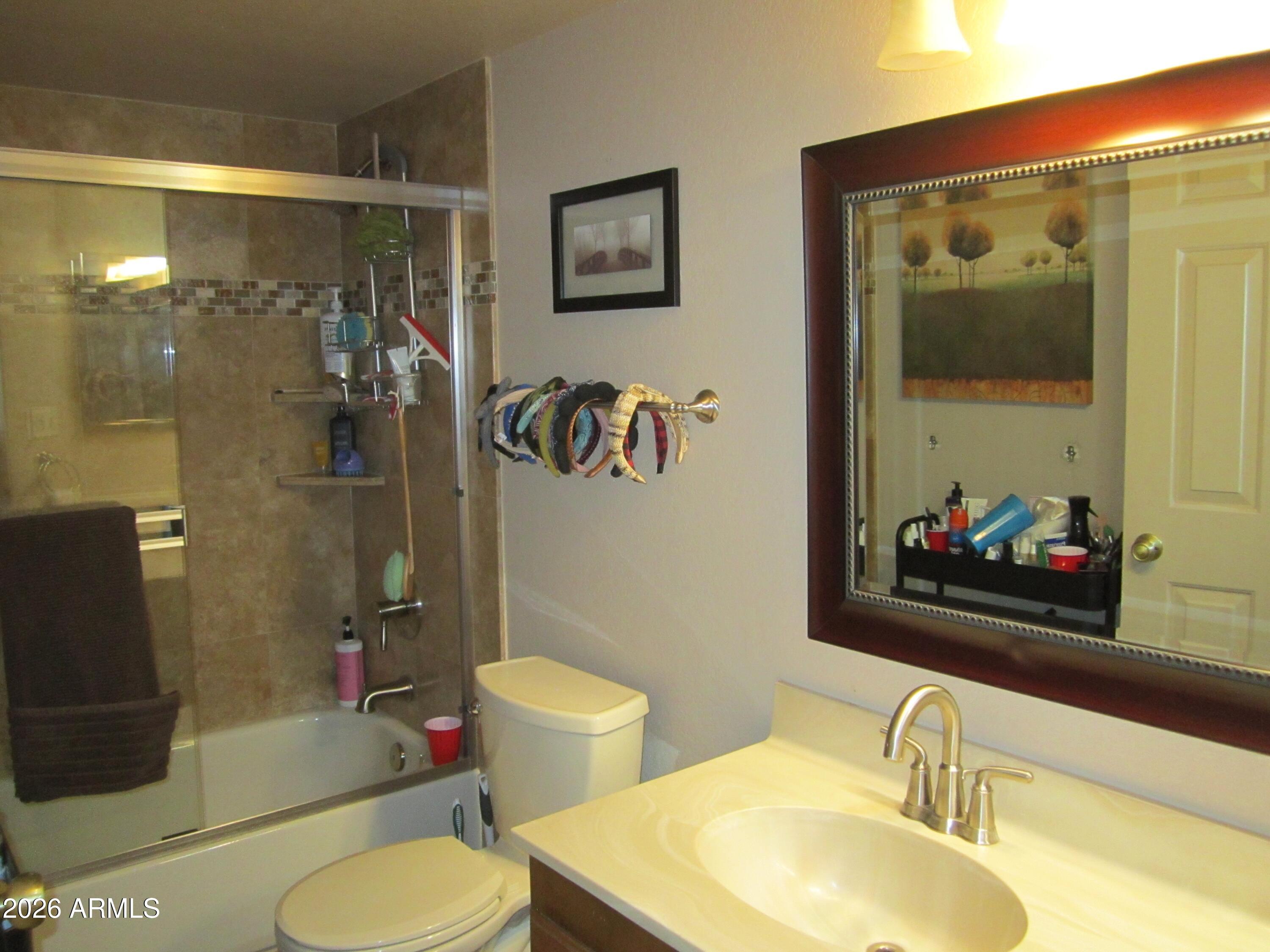 4303 East Cactus Road, Unit 423 Phoenix, AZ 85032 - Photo 14 of 39 a bathroom with a sink toilet and shower