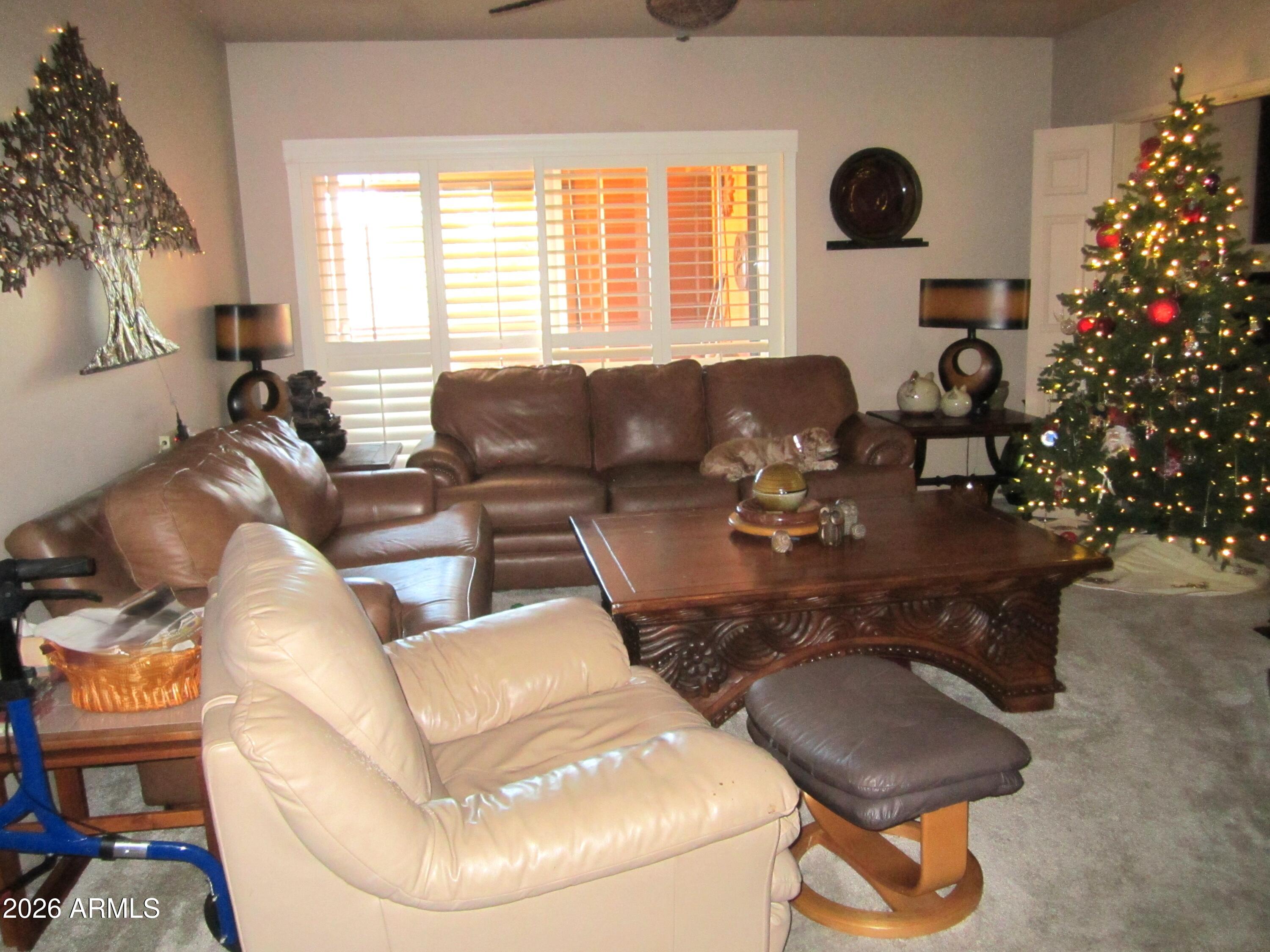 4303 East Cactus Road, Unit 423 Phoenix, AZ 85032 - Photo 2 of 39 a living room with furniture a flowers and a fireplace