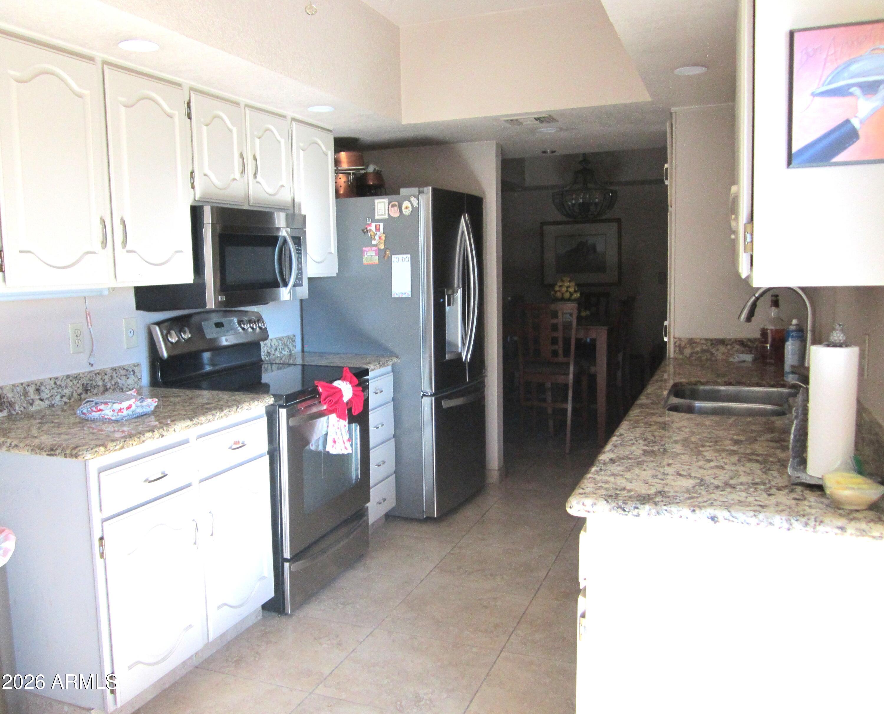 4303 East Cactus Road, Unit 423 Phoenix, AZ 85032 - Photo 7 of 39 10 423 VIEW FROM IKITCHEN TO DINING ROOM
