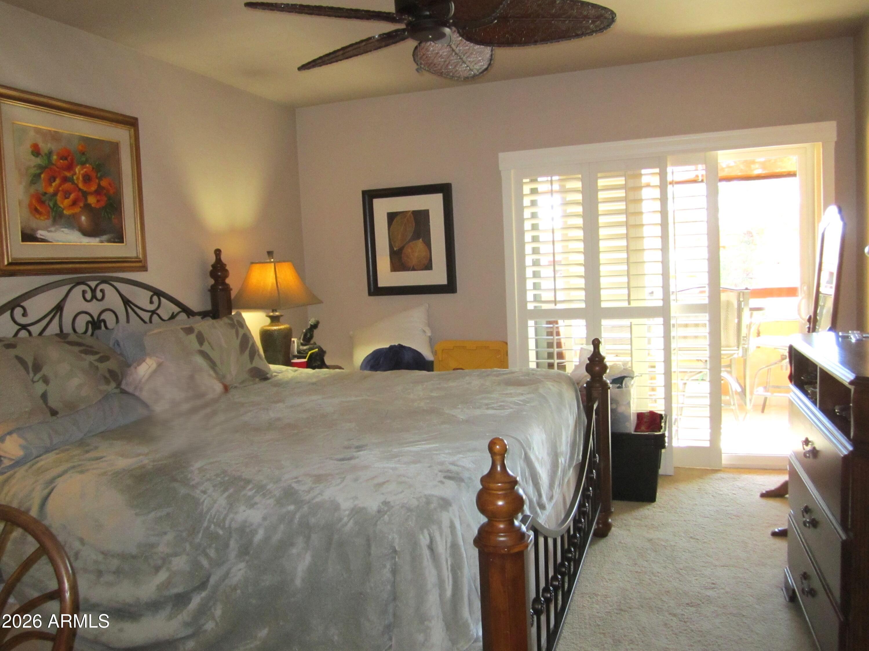 4303 East Cactus Road, Unit 423 Phoenix, AZ 85032 - Photo 8 of 39 a bed room with a bed and a tv