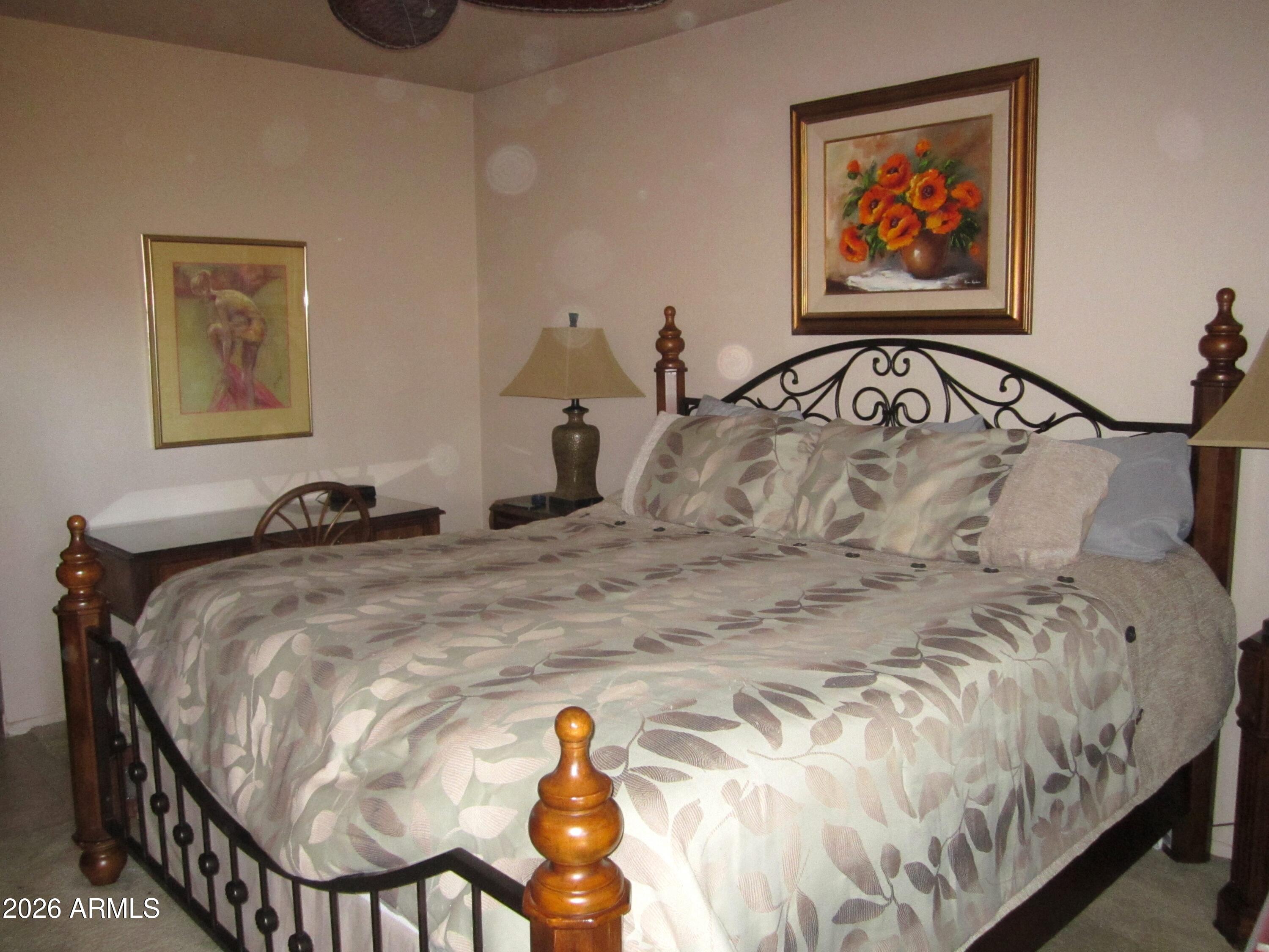 4303 East Cactus Road, Unit 423 Phoenix, AZ 85032 - Photo 9 of 39 a bedroom with a bed and a painting on the wall