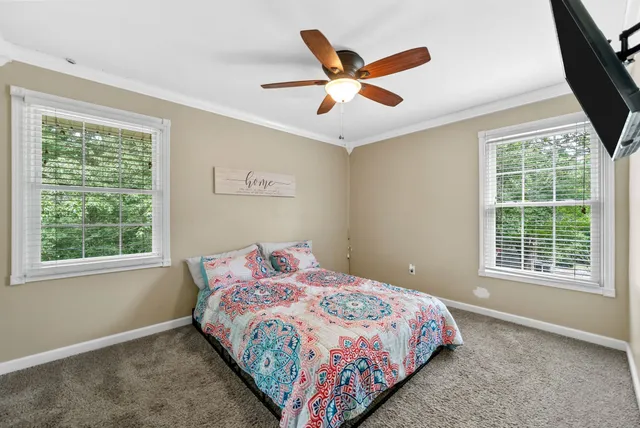 a bedroom with a large bed and a large window