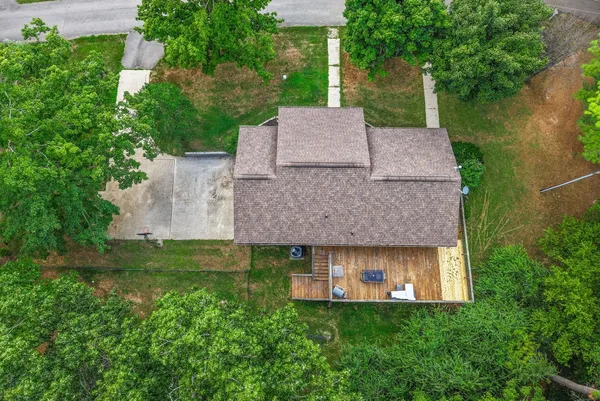 an aerial view of residential houses with outdoor space and city view