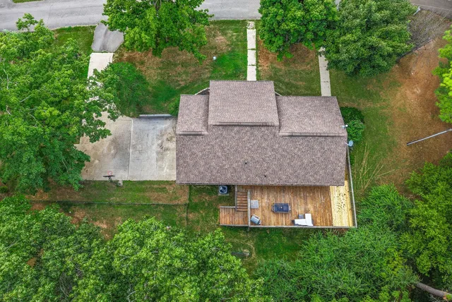 an aerial view of residential houses with outdoor space and city view