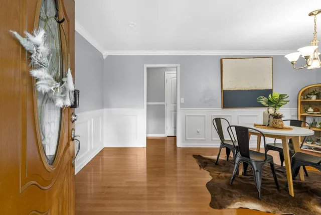 a view of a dining room with furniture and wooden floor