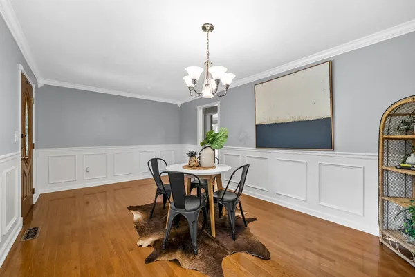 a view of a dining room with furniture and wooden floor