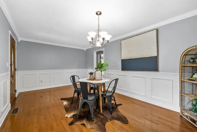 a view of a dining room with furniture and wooden floor