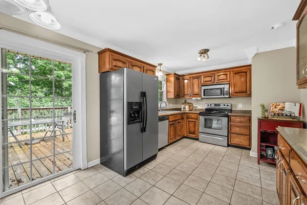 a kitchen with stainless steel appliances a refrigerator sink and stove