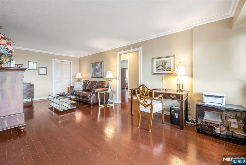 125 Prospect Avenue, Unit 16C Hackensack, NJ 07601 - Photo 11 of 35 a living room with furniture and wooden floor