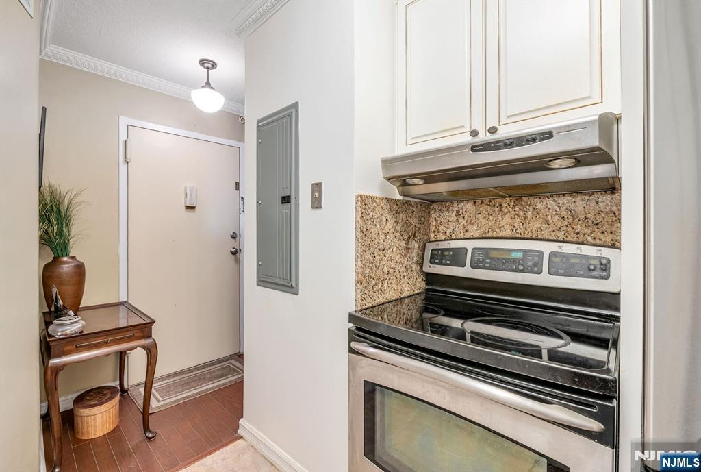 125 Prospect Avenue, Unit 16C Hackensack, NJ 07601 - Photo 22 of 35 a kitchen with a stove and a microwave