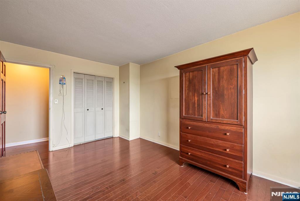 125 Prospect Avenue, Unit 16C Hackensack, NJ 07601 - Photo 28 of 35 an empty room with wooden floor and closet